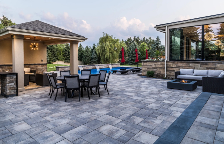 Deck with glass railings and stone accents at Four Seasons Estate