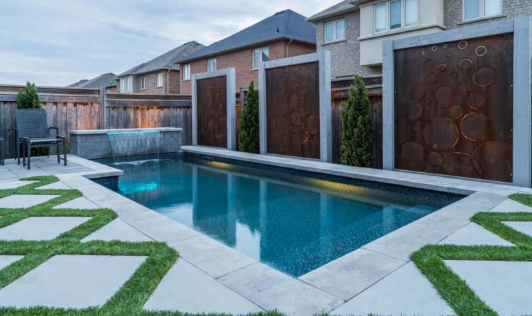 Close-up of a poolside area with modern landscaping and seating.