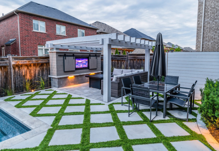 Backyard space with a contemporary pool and stone patio.