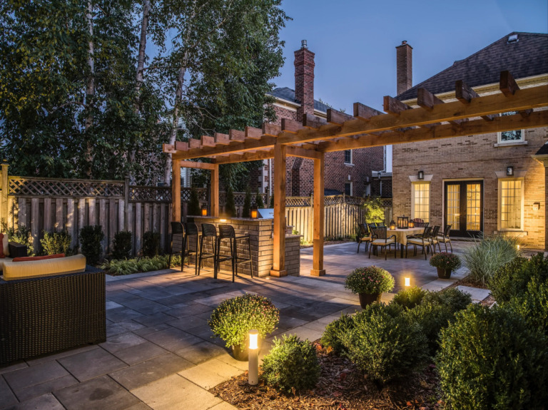 Backyard oasis with a sleek swimming pool, stylish outdoor furniture, and lush plants.