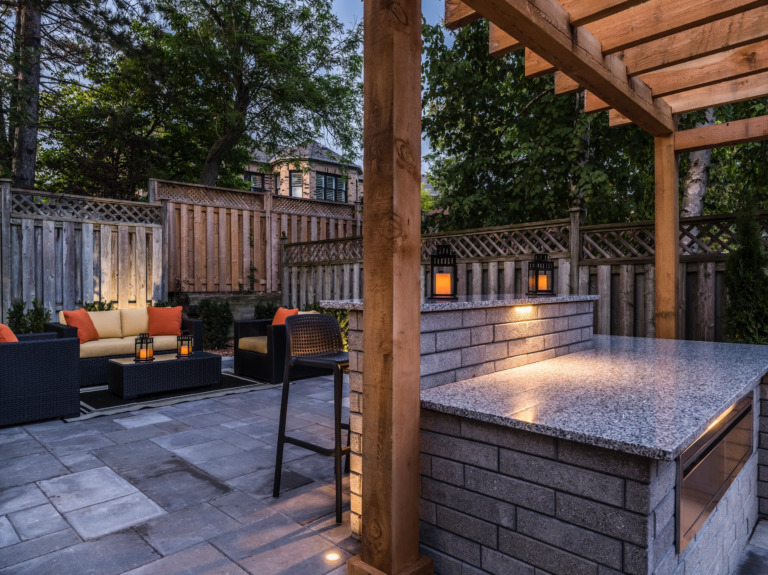 Serene outdoor space showcasing a modern patio, water features, and manicured greenery.