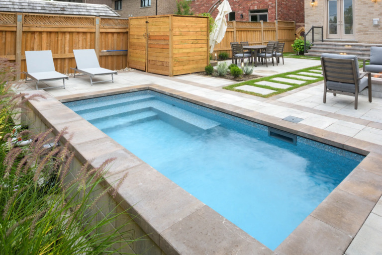 Pathway leading to a pool, with a view of the water.