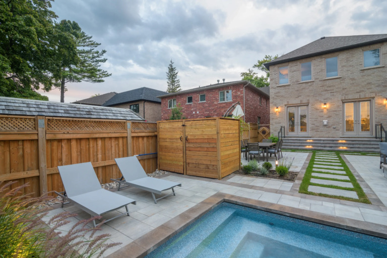 Pathway leading to a pool, surrounded by carefully arranged plants.