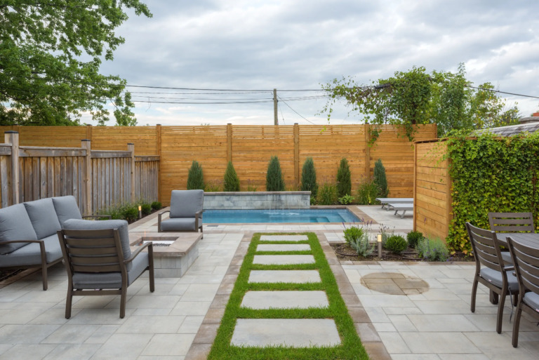 Pathway to the pool, showcasing elegant landscaping.