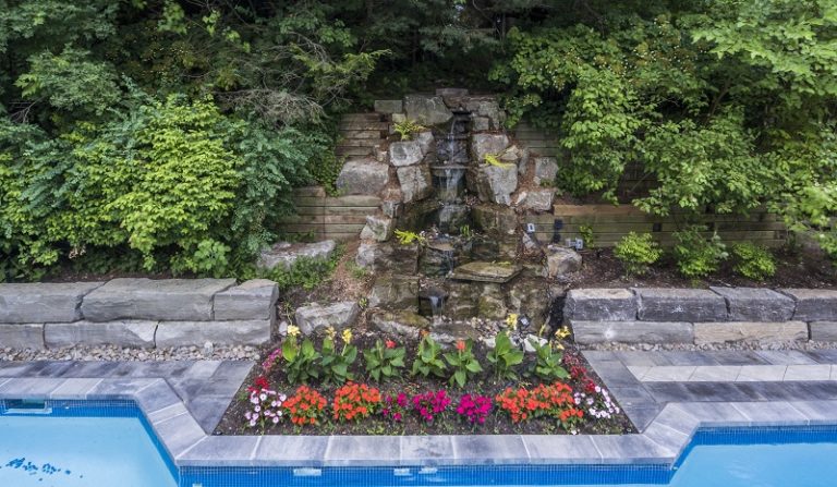 Front view of a contemporary office building with a mix of glass and metal materials.