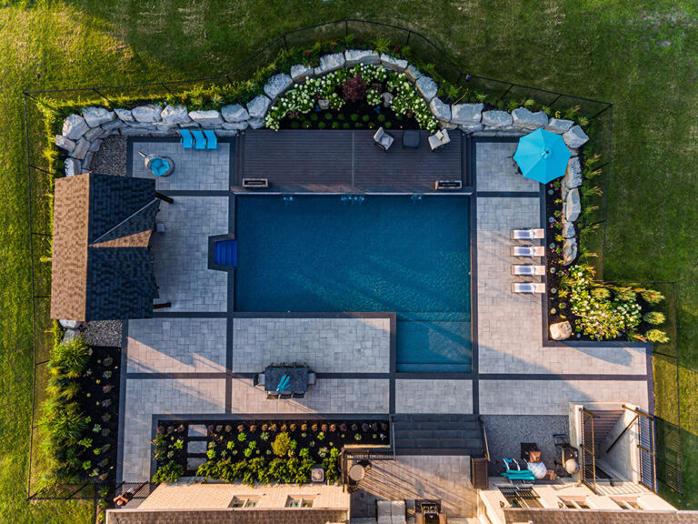 Aerial view of a modern residential property with landscaped backyard and pool.