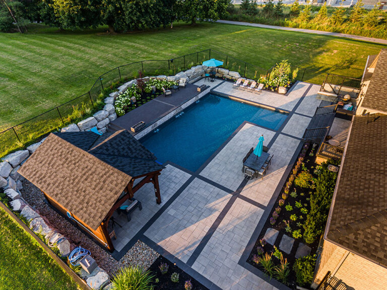 Aerial view of a contemporary backyard with an elegant pool and garden.