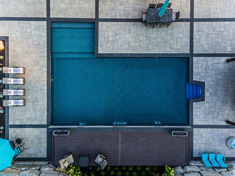 Aerial view of a large residential property with landscaped backyard and pool.