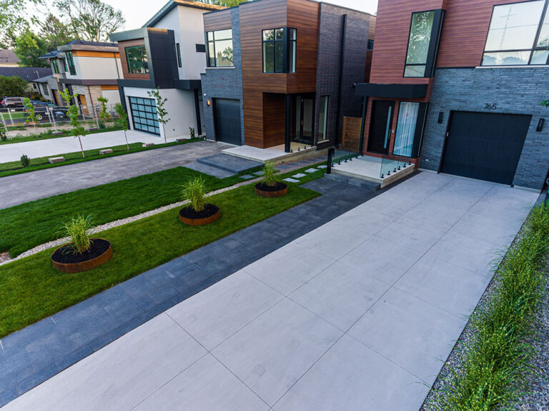 Aerial view of a landscaped backyard with a modern pool and patio.