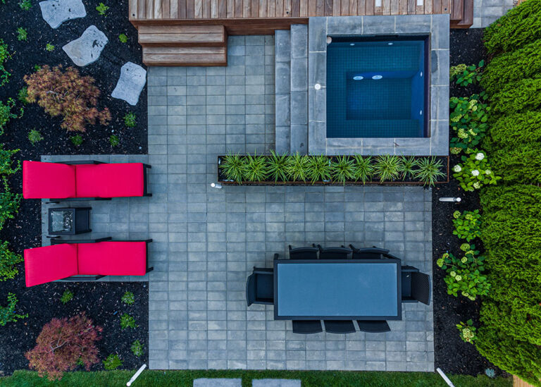 Aerial shot of a modern home with a pool and landscaped backyard.