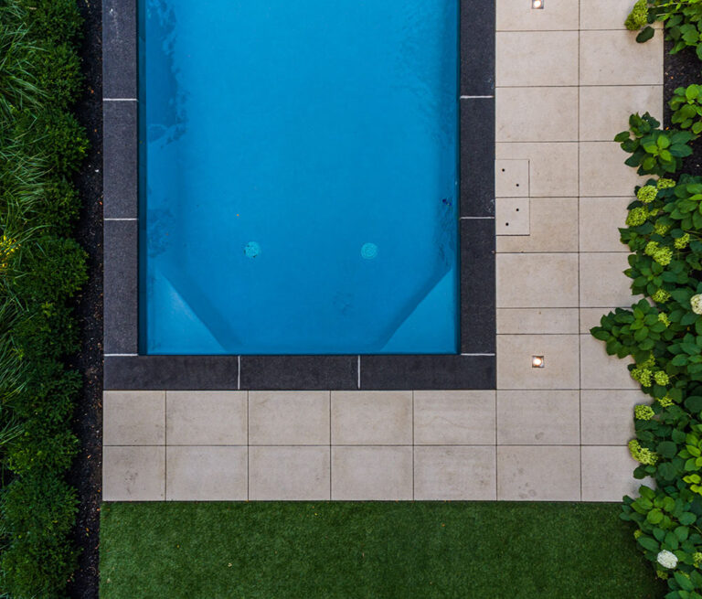 Aerial shot of a landscaped garden with a pool and modern outdoor design.