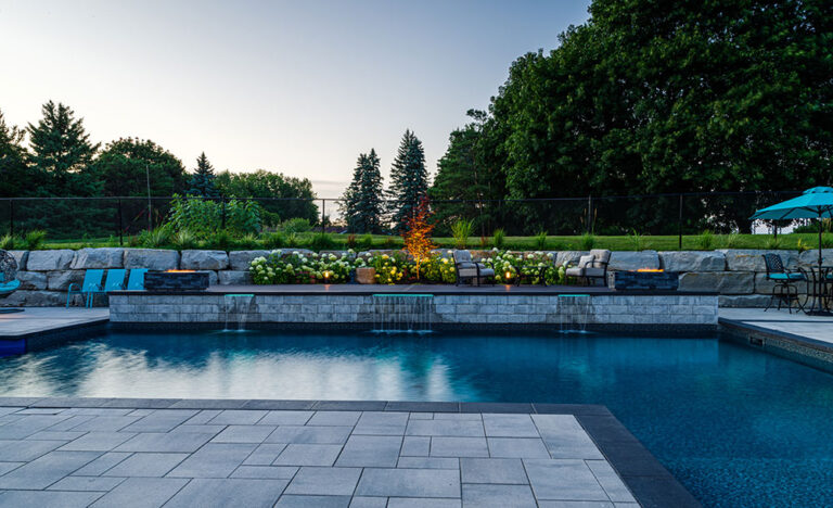Sleek backyard pool design with minimalist features and greenery in the background.
