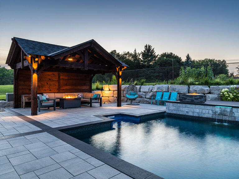 Panoramic view of a stylish backyard with a pool and surrounding outdoor entertainment area.
