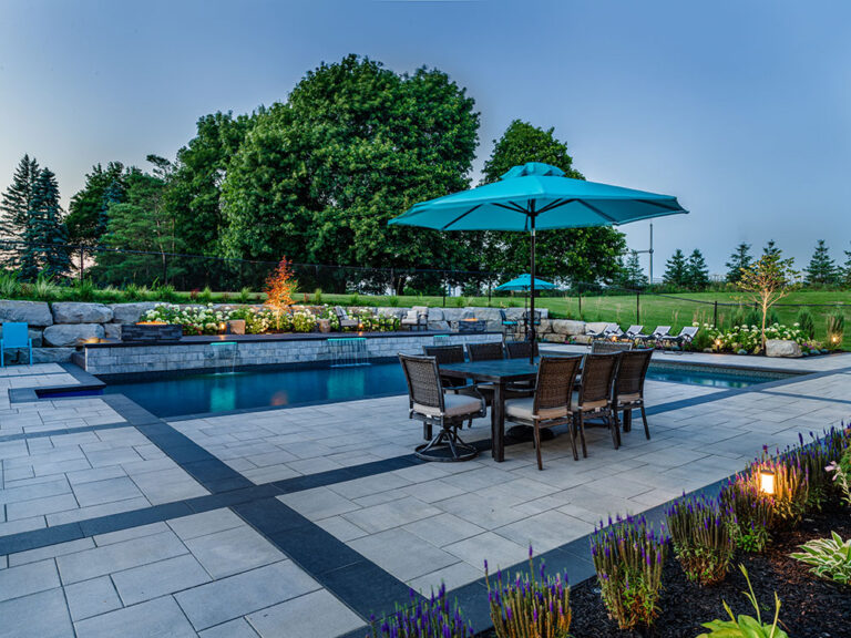 Close-up of a modern pool area with sleek design and surrounding greenery.
