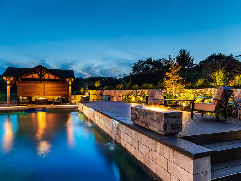 Luxurious backyard with an elegant pool and custom outdoor seating arrangement.