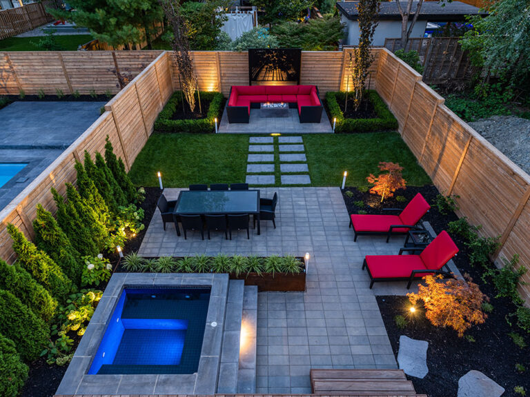 Luxury backyard with modern pool, patio, and landscaping.