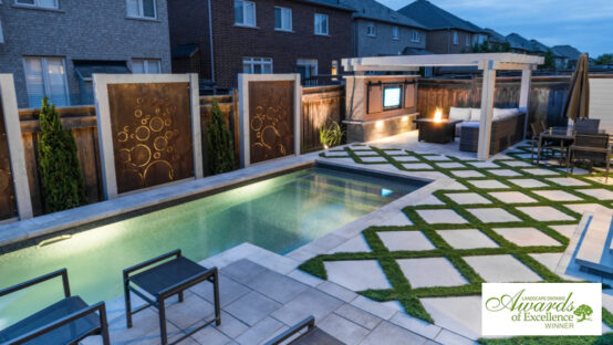 Bold and bubbly backyard pool design with modern landscaping and seating.