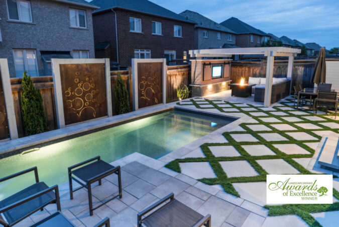 Bold and bubbly backyard pool design with modern landscaping and seating.