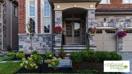 Luxurious backyard with modern pool, patio, and landscaping featuring a spacious seating area, sleek design, and greenery in a residential setting.