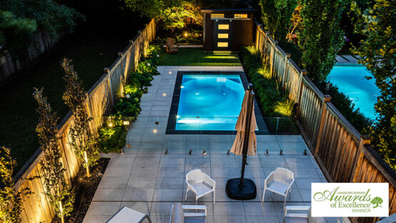Thumbnail image of a landscaped residential backyard with a pool and seating area.