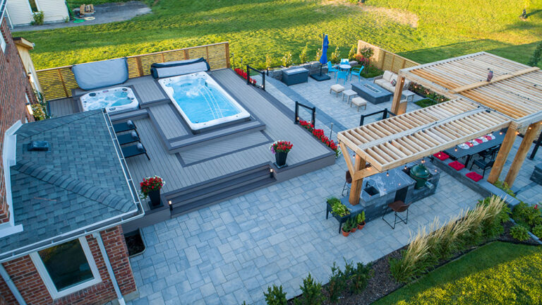 Aerial view of a luxurious backyard pool and landscaping with contemporary design.