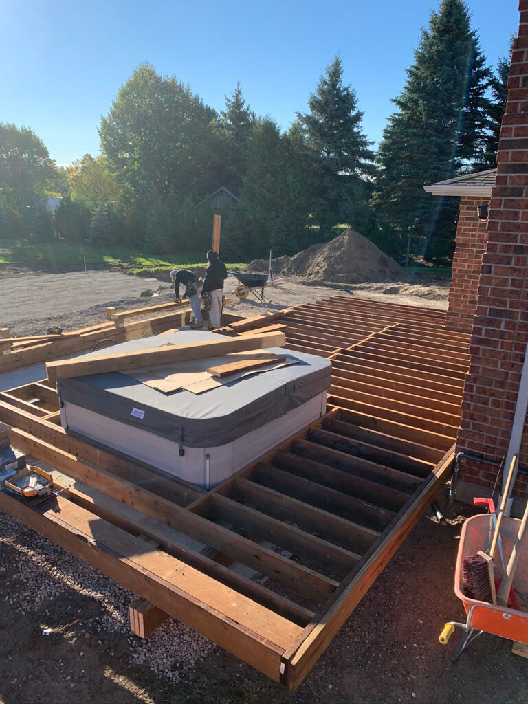 Beautiful backyard pool surrounded by vibrant garden and stylish stonework.
