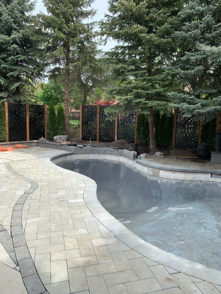 Deer Chase backyard - modern outdoor patio area with pool and lush landscaping.