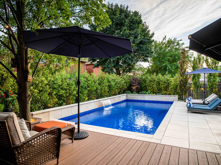 Outdoor living area with modern decor, pool, and clean landscape design.