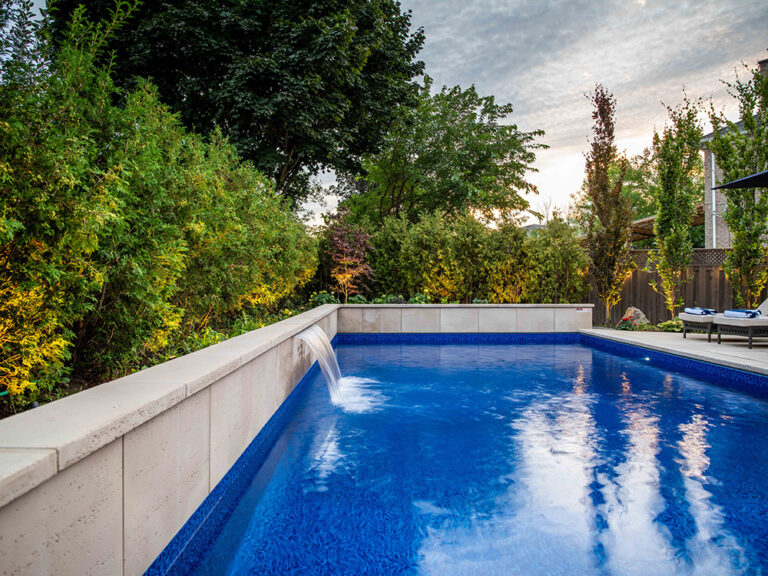 Elegant backyard setup with modern furniture and a custom-designed swimming pool.