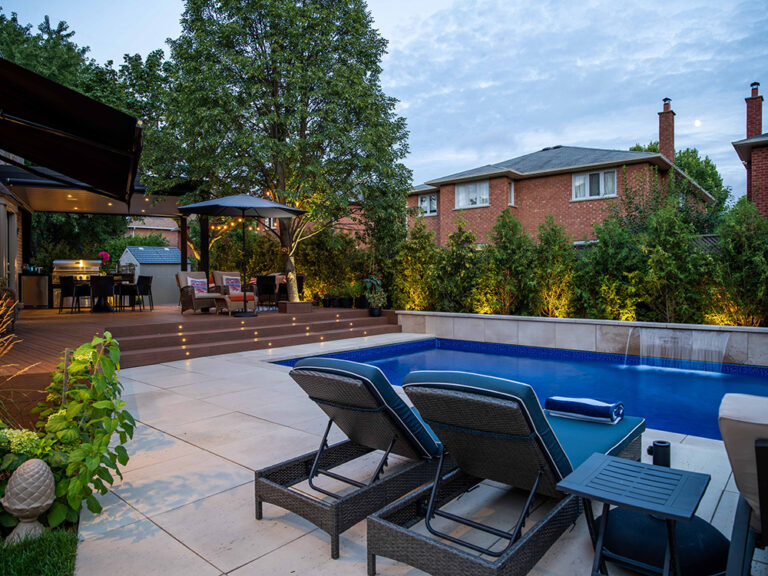 Contemporary outdoor living space featuring a custom pool and well-maintained landscaping.