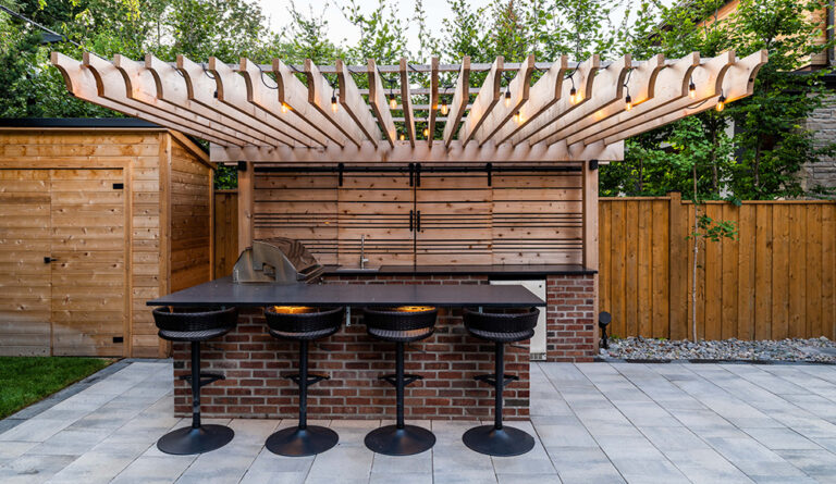 Elegant outdoor area featuring a pool, lounge chairs, and modern landscaping.