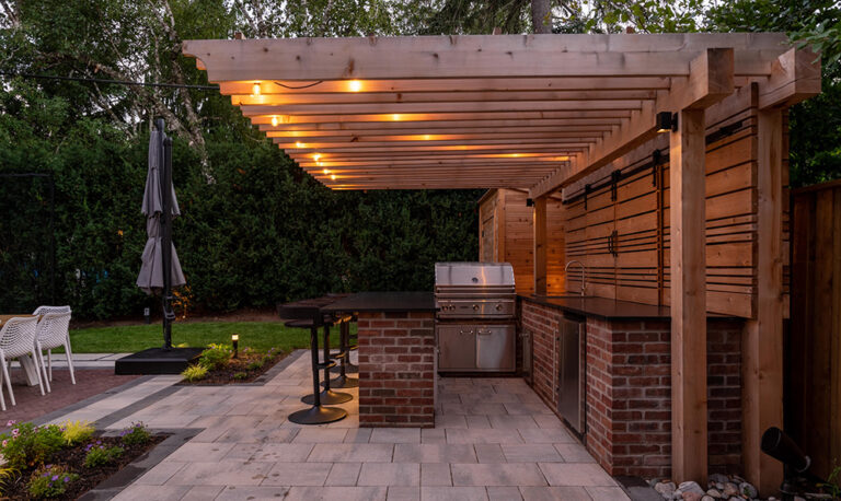 Luxurious backyard with a modern pool, outdoor seating, and surrounding greenery.