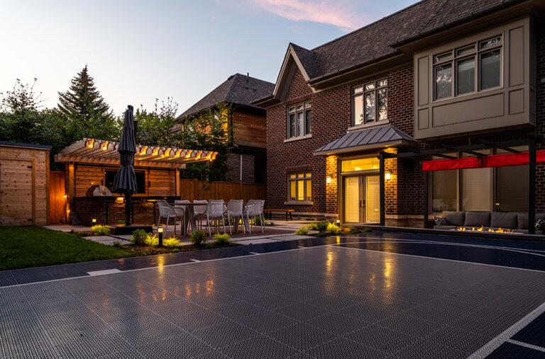 Modern backyard with a luxurious pool, sleek outdoor furniture, and well-maintained lawn.