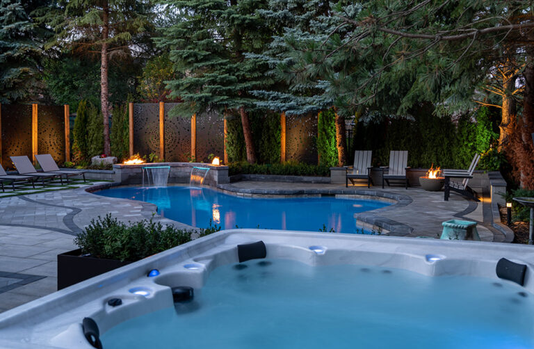 Chic backyard patio with outdoor furniture, surrounded by greenery and a pool.