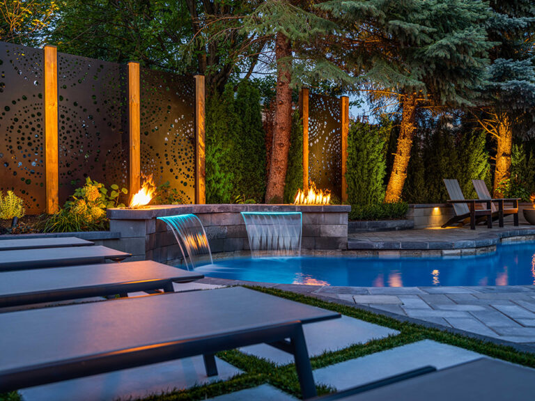 Elegant backyard firepit area with comfortable seating and landscaped surroundings.