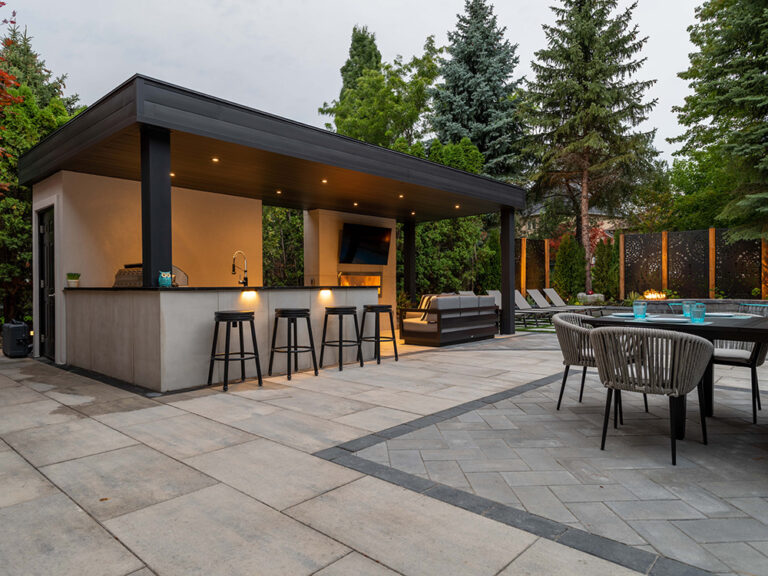 Backyard view showcasing a contemporary pool, stone pathway, and surrounding greenery.