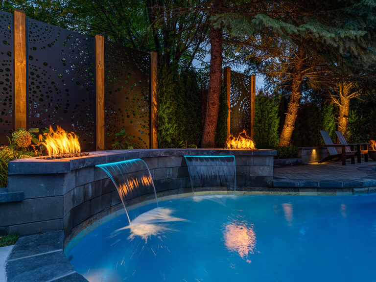 Stylish backyard with a large pool, stone patio, and well-maintained garden.