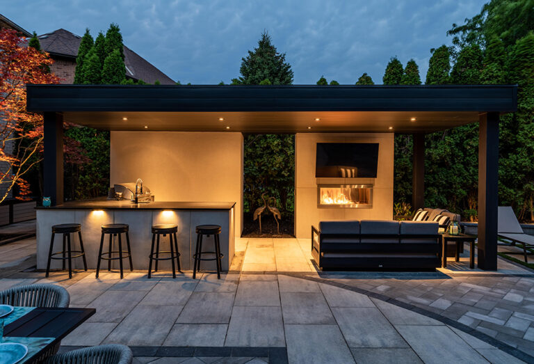 Modern outdoor seating area in a beautifully landscaped backyard with a pool.