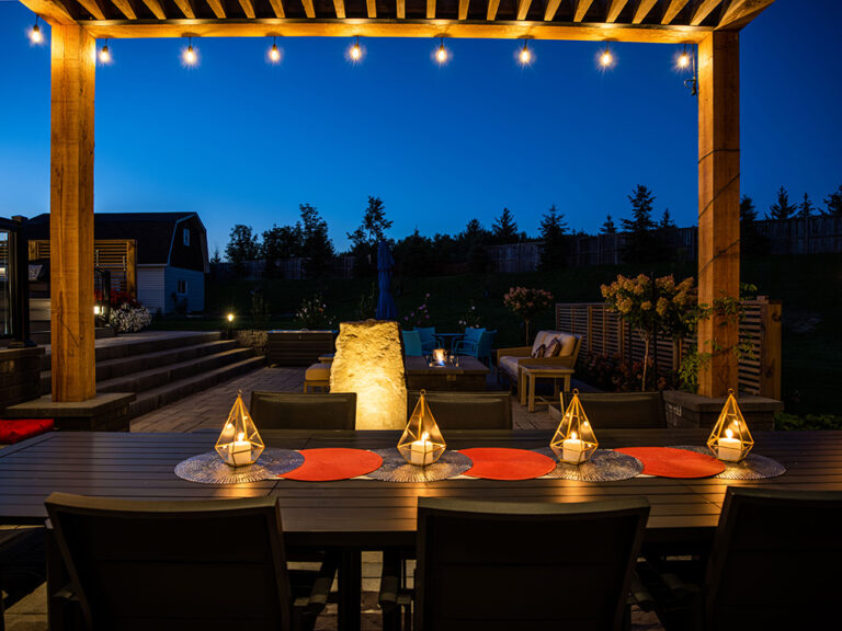 Sophisticated backyard design with pool, stone patio, and lush greenery.