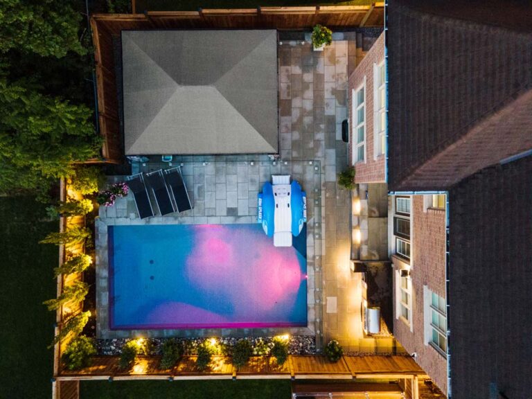 Stylish backyard with wooden deck and garden plants