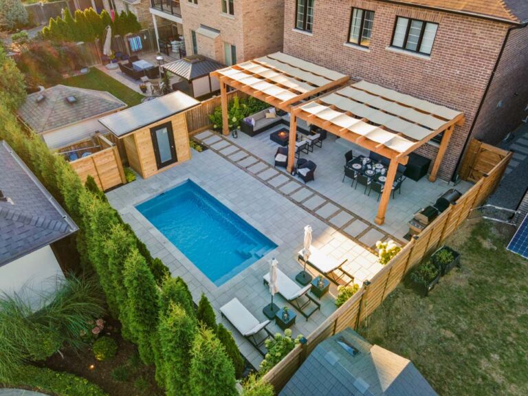 Contemporary backyard with a mix of stone and greenery