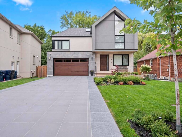 Elegant backyard with a mix of lawn and stone patio