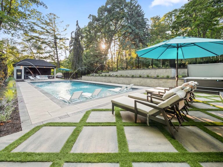 Modern backyard with a custom wooden deck and outdoor lounge furniture