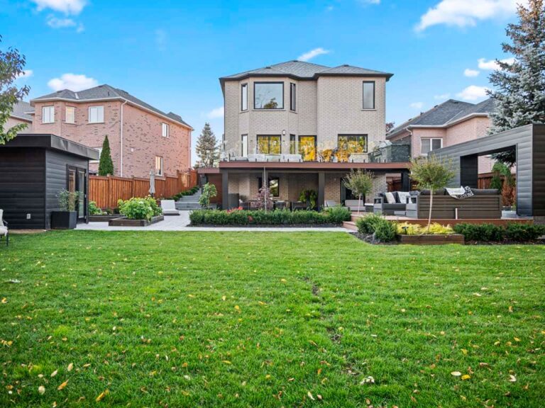 Backyard with stone paving, seating, and greenery