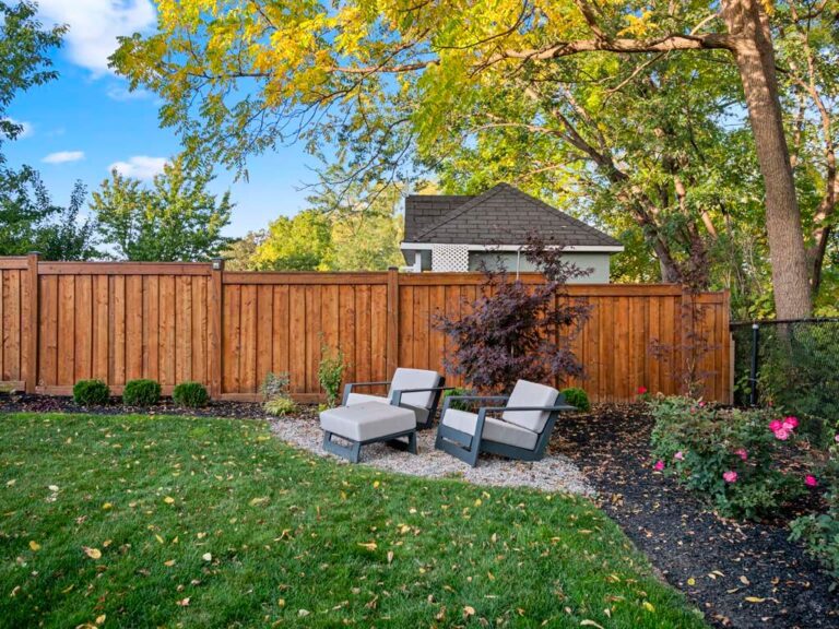 Modern backyard design with a mix of grass and paving