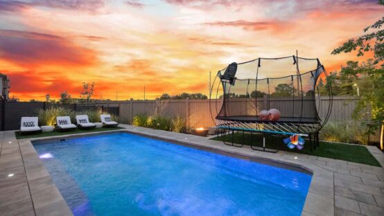 Spacious backyard with pool and lounge chairs