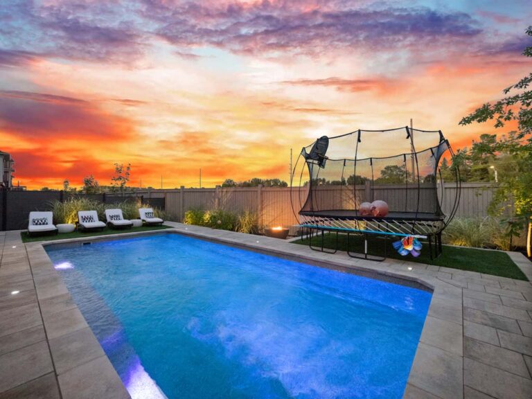 Spacious backyard with pool and lounge chairs