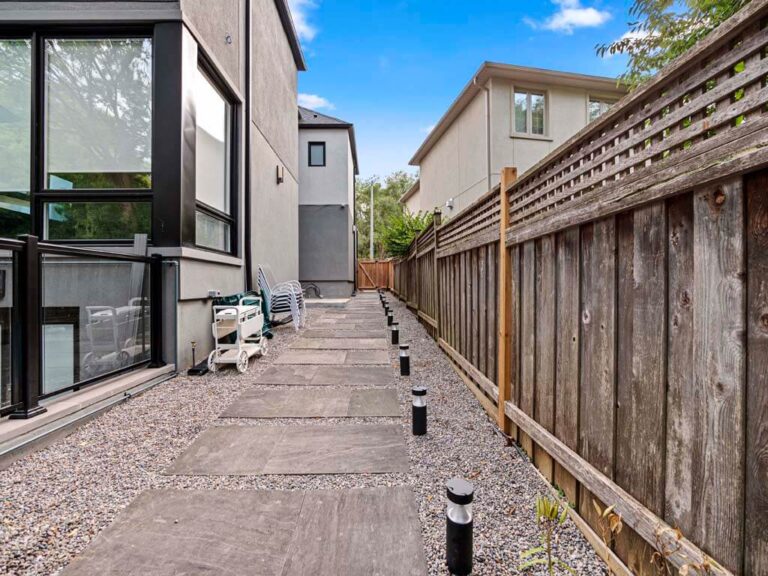 Beautifully landscaped backyard with a stone pathway
