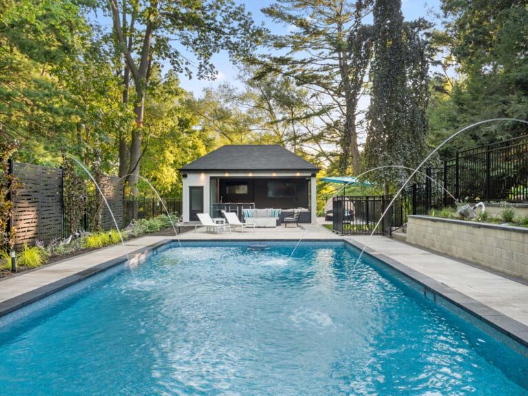 Spacious backyard with a wooden deck, fire pit, and outdoor seating