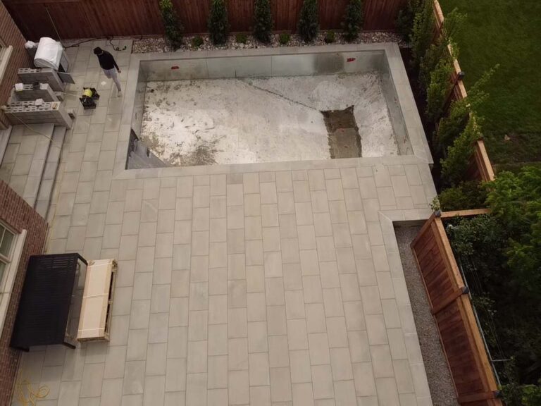 Outdoor living space with a stone fireplace and seating